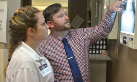 Doctor and student studying x-ray.